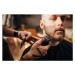 Fotografie Male barber cutting beard of client in barber shop, South_agency, 40 × 26.7 cm