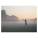 Fotografie Woman practicing yoga in foggy field, Tom Merton, 40 × 30 cm