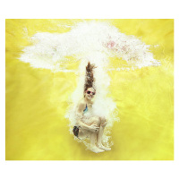 Fotografie Girl jumping into water on yellow background, Stanislaw Pytel, 40 × 35 cm