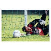 Fotografie Male football goalie lying on field,, Photo and Co, 40x26.7 cm