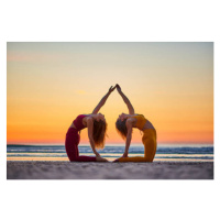 Fotografie Two women doing yoga on the beach at sunrise, Jose Martinez, 40 × 26.7 cm