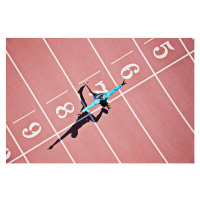 Fotografie Runner crossing finishing line on track, Paul Bradbury, 40 × 26.7 cm