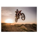 Fotografie Motocross rider performing high jump at sunset., skynesher, 40x30 cm