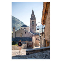 Fotografie Young Adult Woman Walking Through Quaint, Glasshouse Images, 26.7 × 40 cm