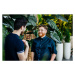 Fotografie Two Colleagues Standing Amongst Potted Plants, Tom Werner, 40 × 26.7 cm