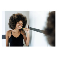 Fotografie Multiracial woman brushing teeth in bathroom, Drazen_, 40 × 26.7 cm