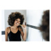 Fotografie Multiracial woman brushing teeth in bathroom, Drazen_, 40 × 26.7 cm