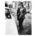 Fotografie Jagger, singer with the Rolling Stones, about to get into his car, c.1970, 30 × 40 cm