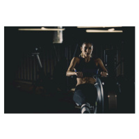 Fotografie Strong woman doing seated row exercise, fotostorm, 40 × 26.7 cm