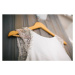 Fotografie Elegant wedding dress hanging on gray wall, JovanaT, 40 × 26.7 cm