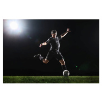 Fotografie Soccer player kicking ball on grass,, Stanislaw Pytel, 40x26.7 cm