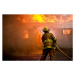 Fotografie Firefighter spraying water at a house fire, chuckmoser, 40 × 26.7 cm