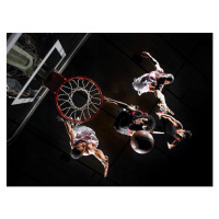 Fotografie Basketball player dunking ball over opponents,, D Miralle, 40 × 30 cm