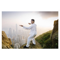Fotografie Man practicing Tai Chi infront of skyline, Martin Puddy, 40x26.7 cm