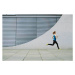 Fotografie Woman running in front of a building, Luis Alvarez, 40 × 26.7 cm