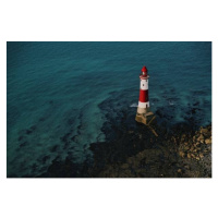 Fotografie Red and white lighthouse on the sea shore., Mykola  Romanovskyy, 40 × 26.7 cm