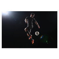 Fotografie Football player jumping with ball on, Stanislaw Pytel, 40x26.7 cm