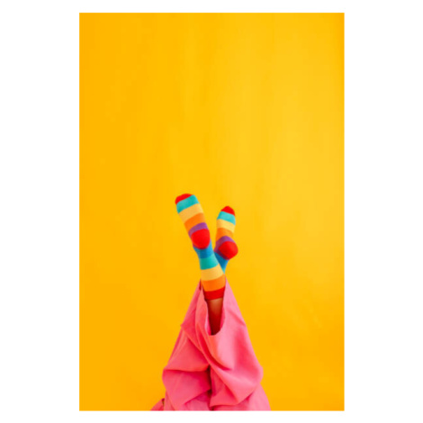 Fotografie Woman wearing colorful socks against yellow, Westend61, 26.7 × 40 cm