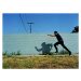 Fotografie Policeman running next to cement wall,, Sean Murphy, 40 × 30 cm