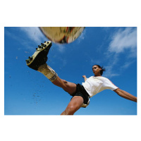 Fotografie Soccer player kicking ball, low angle, David Madison, 40x26.7 cm