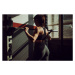 Fotografie Fit young woman training alone in dark gym, South_agency, 40 × 26.7 cm