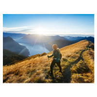 Fotografie Woman hikes along ridgecrest above lake, valley, Milo Zanecchia/ Ascent Xmedia, 40 × 