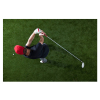 Fotografie A golfer swinging a golf club, overhead view, fStop Images - Halfdark, 40x26.7 cm