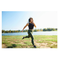 Fotografie Smiling young woman jogging near lake on sunny day, The Good Brigade, 40x26.7 cm